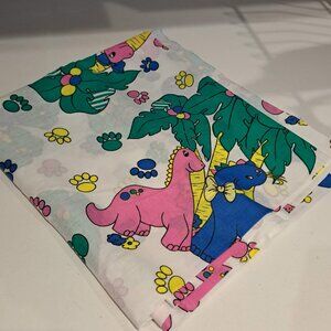 pink and blue cartoon dinosaurs on a white background fabric
